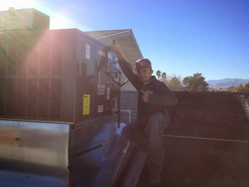 HVAC technician performing Boiler Repair on a rooftop unit in Thurmont